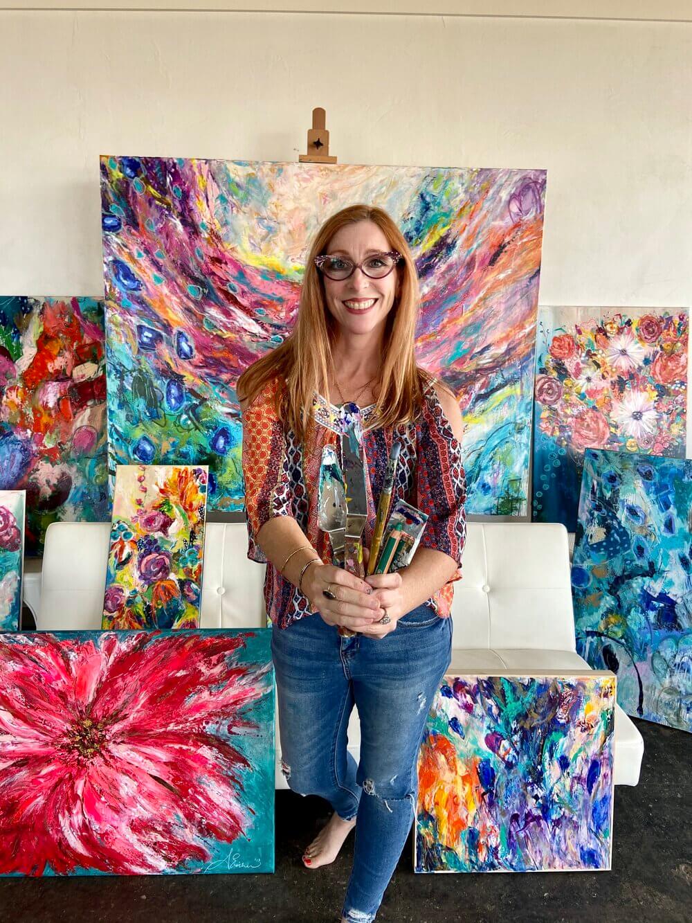 Aimee Eischen surrounded by her artwork